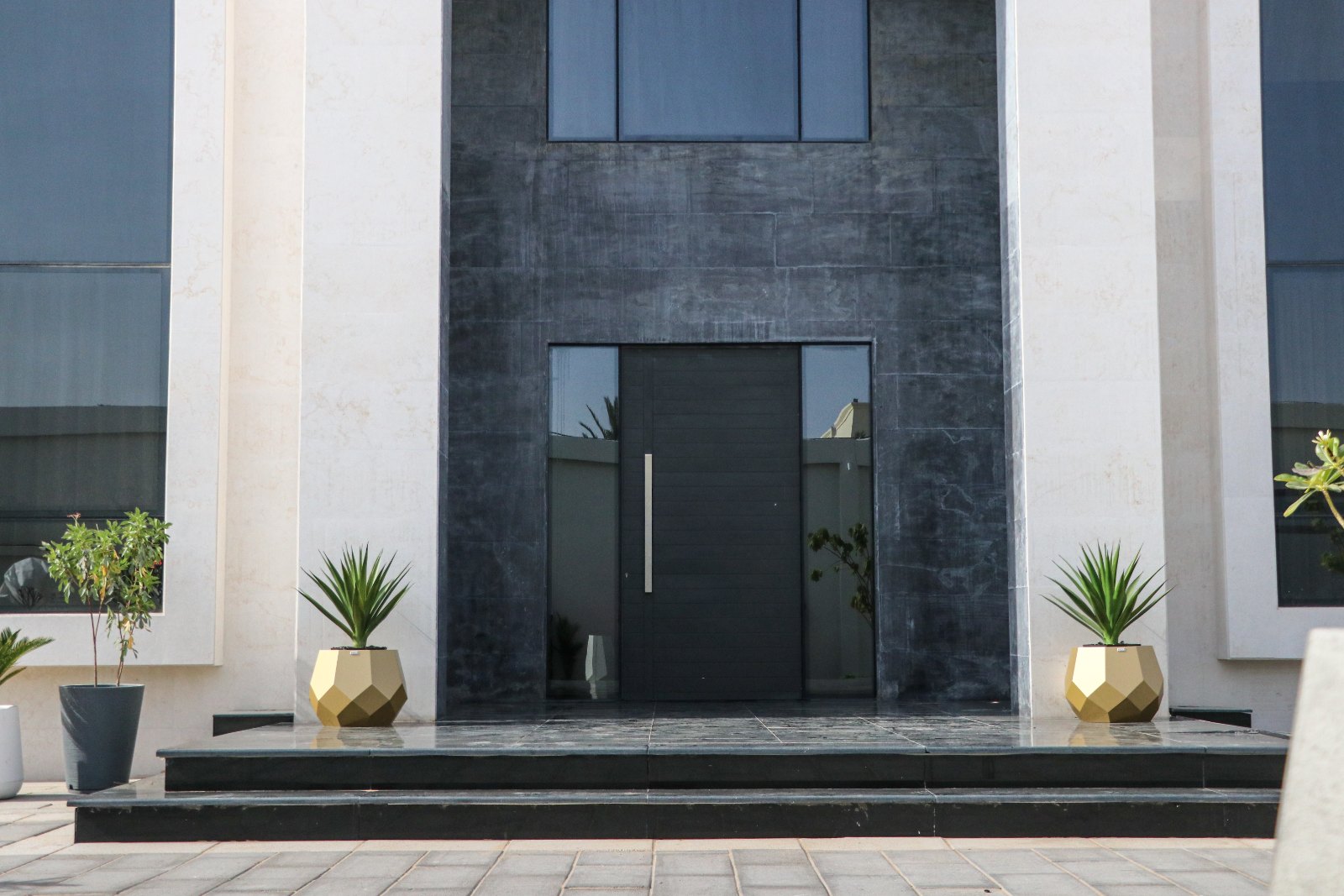 MAZ gold faceted planters at a villa entrance