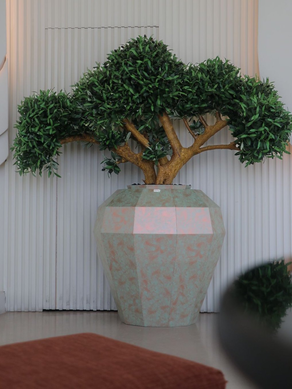 Olive tree in copper planter